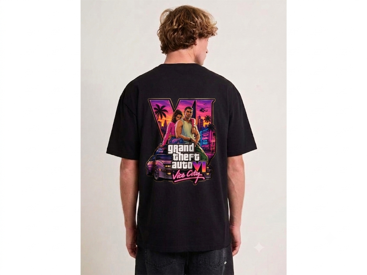 A man viewed from behind wearing a black t-shirt with a large Grand Theft Auto V graphic on the back, set against a plain light gray background.